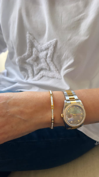 Mother of pearl dainty gold plated bracelet next to Rolex watch inamullumani 