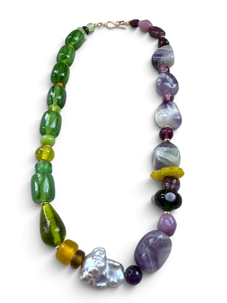 Beaded gemstone necklace in green amethyst purple and baroque pearl unique mixed material on white background inamullumani 