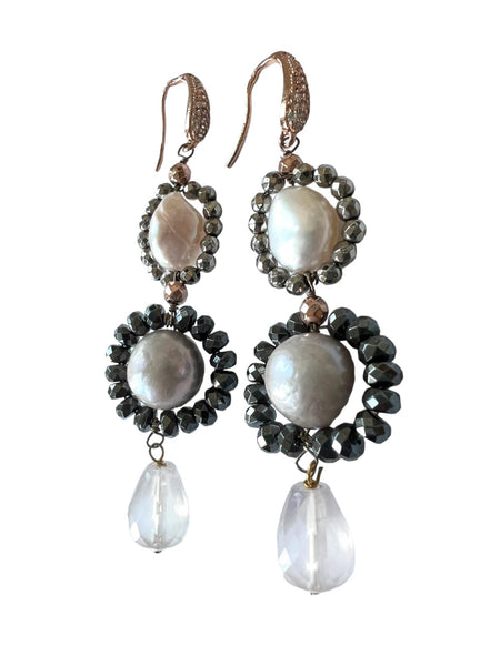 Pair of earrings with baroque pearls and gemstones on a white background