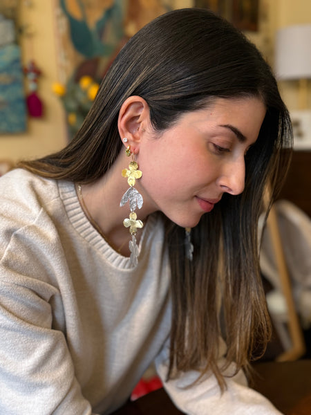 Woman wearing Bloom In Motion Long floral earrings in a casual setting inamullumani 