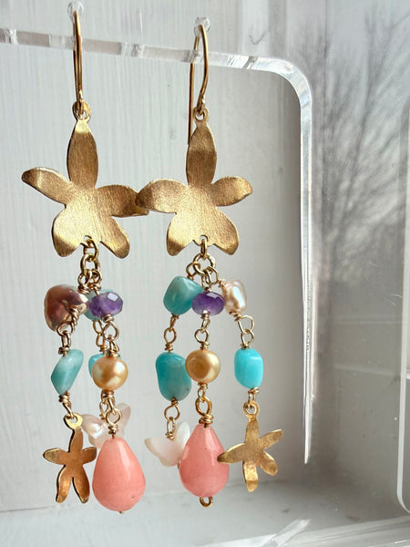 Gold flower-shaped earrings with colorful gemstones and pearls mother of pearl butterfly on a white background inamullumani 