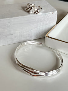 Sahara sterling silver ring and bracelet on white wood background inamullumani 