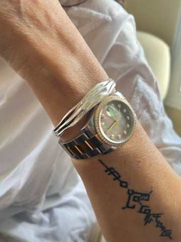 Sahara sterling silver bracelet next to Rolex diamond watch inamullumani 