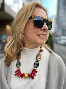 Statement necklace in coral wood and Tibetan agate on blond woman and white shirt inamullumani touch wood 