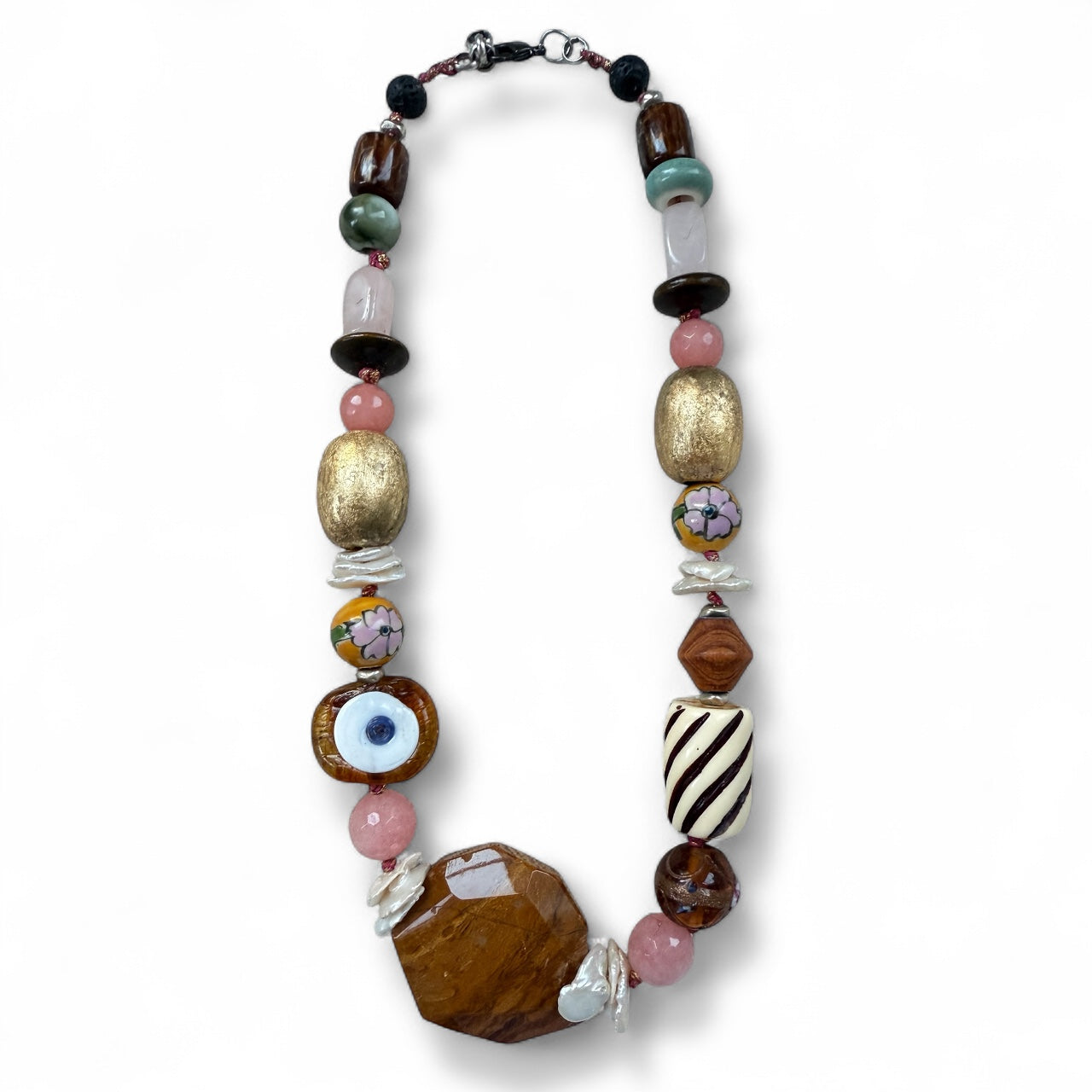 Necklace handmade with various beads and evil eye on a white background
