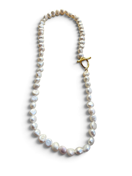 Pearl necklace with irregularly shaped pearls and a gold-tone toggle clasp on a white background perfect holiday gift inamullumani 
