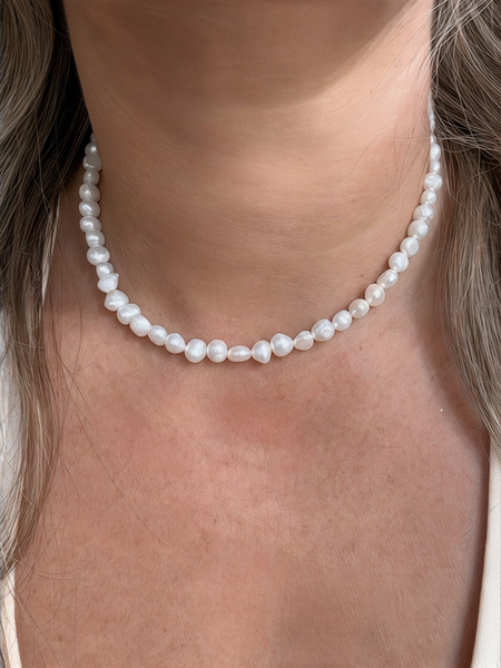 Pearl necklace worn close to the neckline timeless elegance inamullumani 