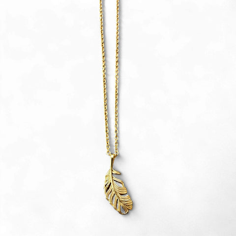 Gold feather necklace on a white background inamullumani X wings for limbs foundation 