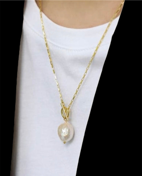 Pearl necklace on white T shirt with gold chain and toggle 