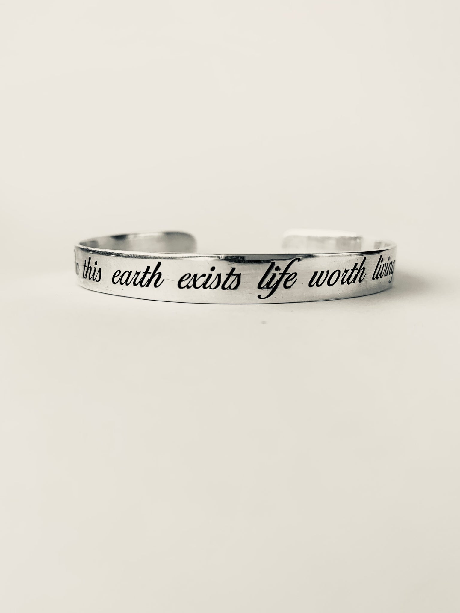 Sterling silver bangle engraved with quote on this earth exists life worth living inamullumani 